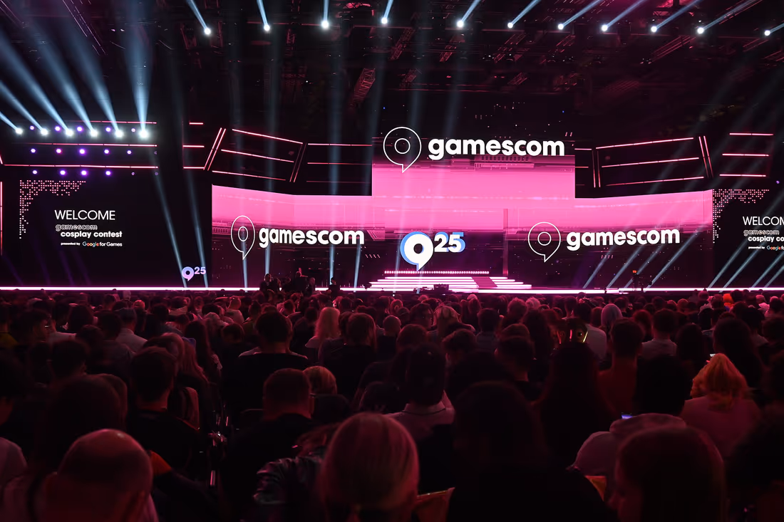 The cosplay contest main stage at gamescom 2025, lit before a full crowd